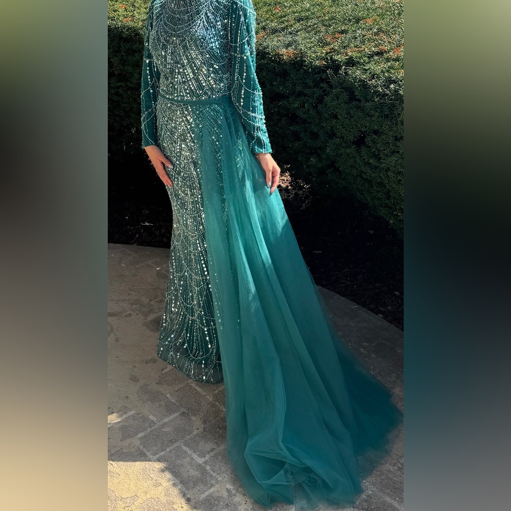 A teal evening gown beaded and sparkly, size 4, comes with a side skirt.
